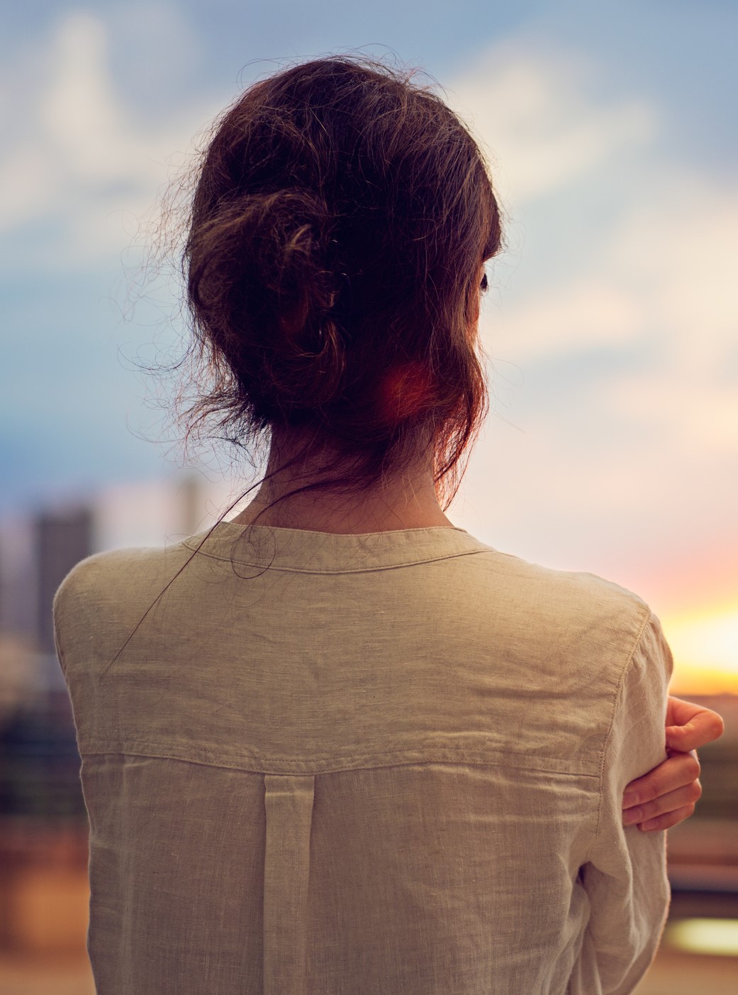 Young girl is watching sunset over Tokyo