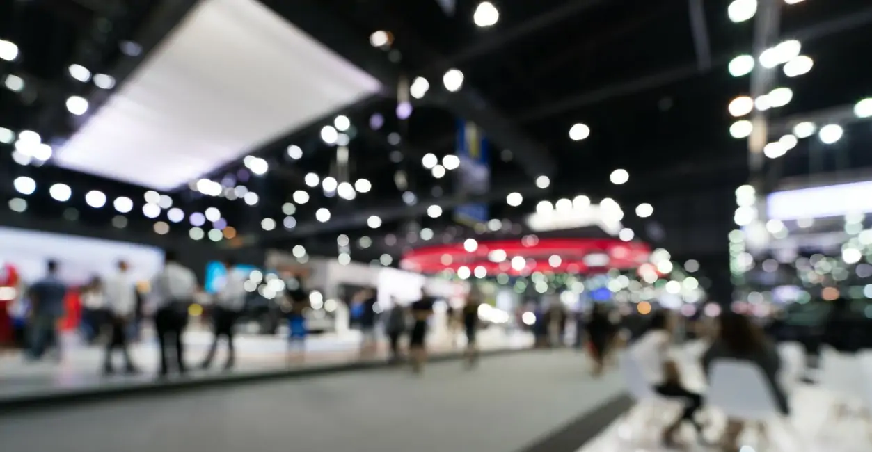 Blurred, defocused background of public event exhibition hall. Business trade show or commercial activity concept